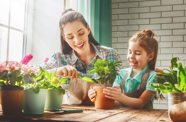 mother and daughter caring for houseplants