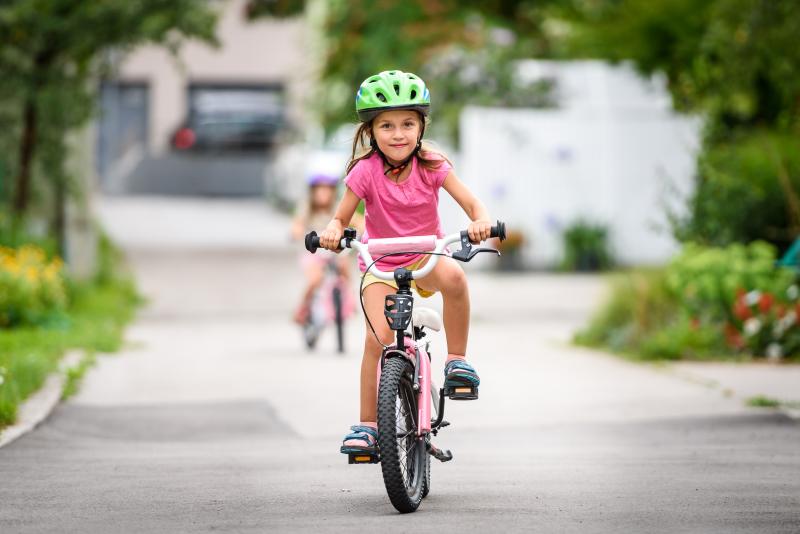 child riding a bike with pedals