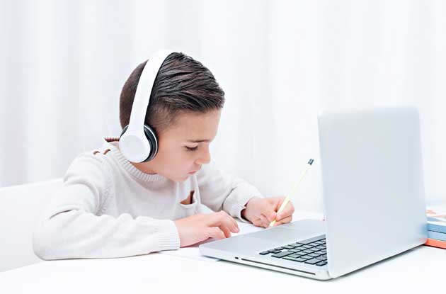 young boy doing work on computer