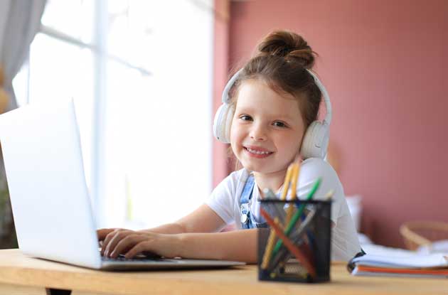 girl doing online tutoring on computer